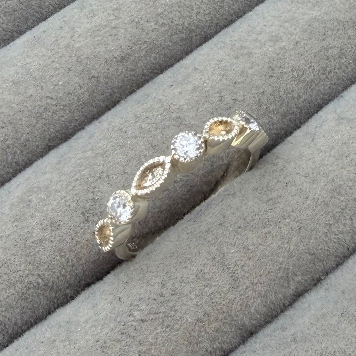 Serrated bezel half marquise cz ring