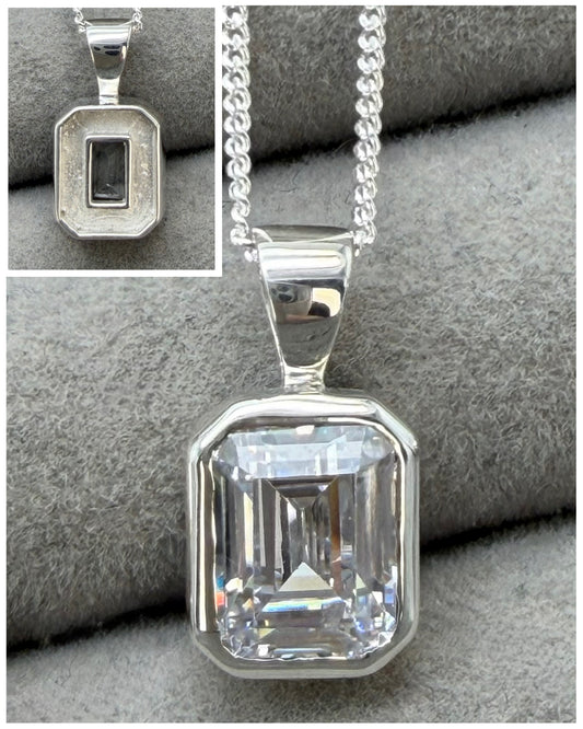 Secretly set emerald cut pendant